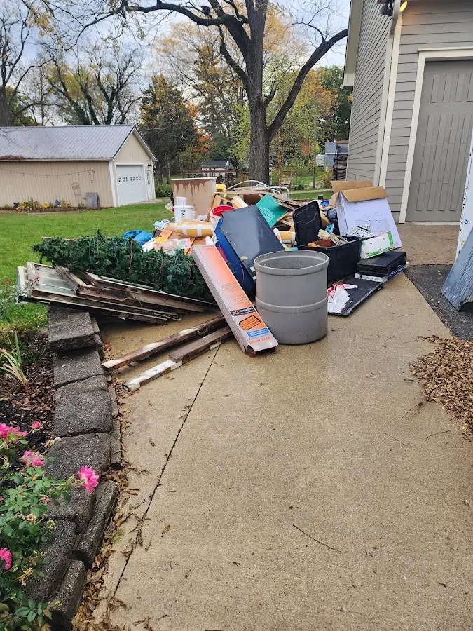 Dumpster being loaded with debris for 10 Yard Dumpster Rental in Elko